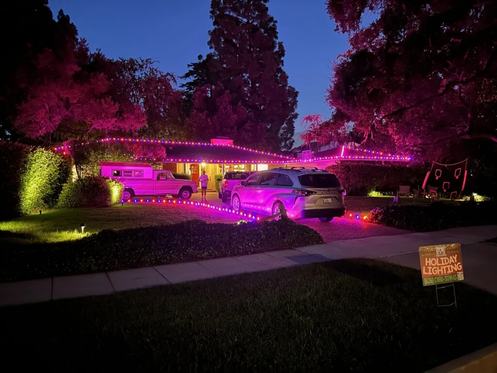 Ranch home with RGB Christmas lighting and Bee Merry service truck on-site